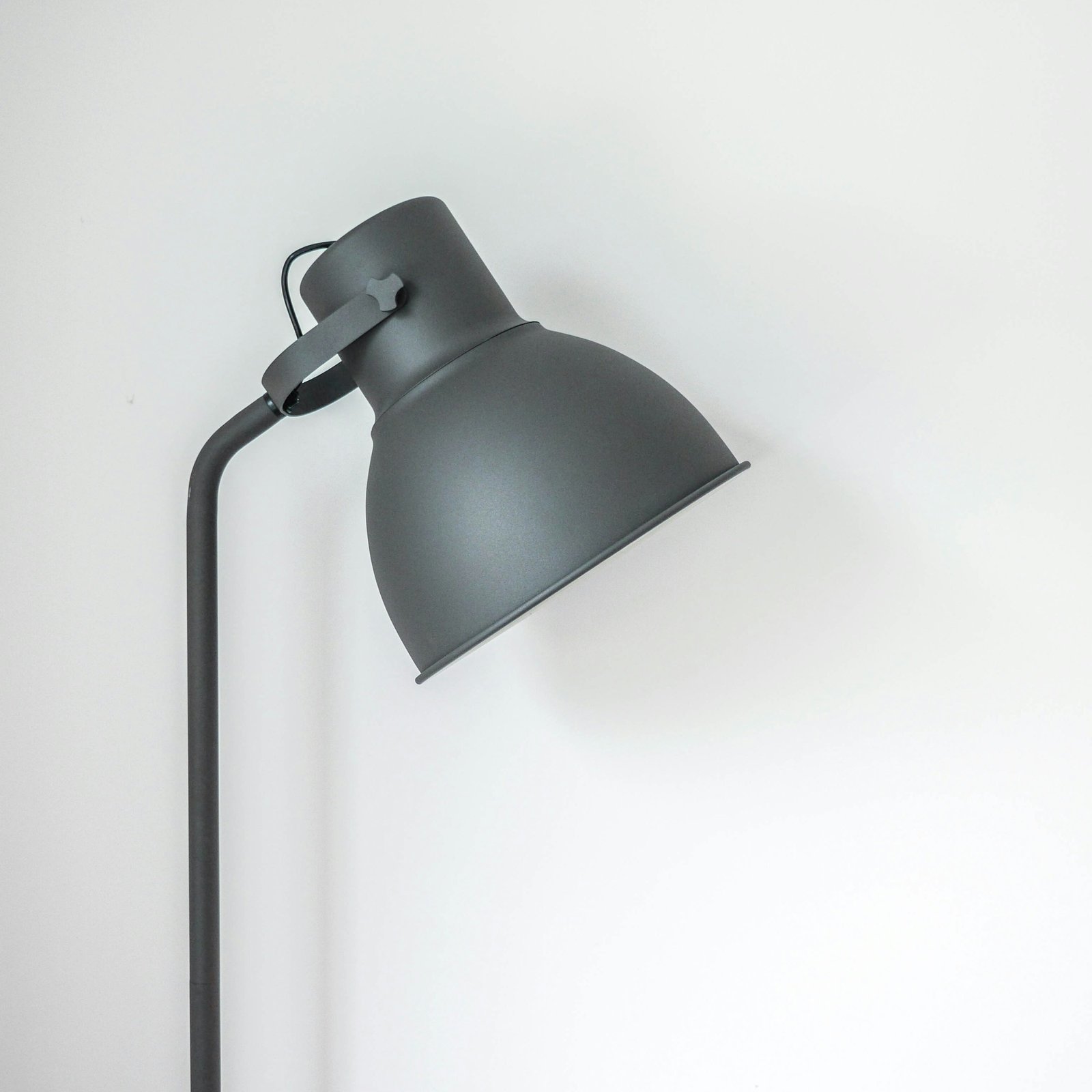 Brass desk lamp on a dark desk